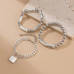 Three-piece silver metal bracelet set featuring a padlock pendant and beaded tubes