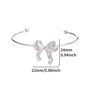 Detail view showing precise dimensions of silver bow open cuff bracelet, 24mm by 22mm