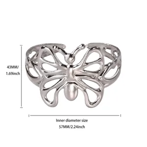 Detail view of silver butterfly open bangle with inner diameter measurement of 57mm.