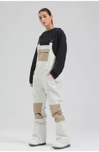 Professional women's white ski bib with tan patches for winter sports outdoor activities