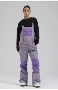 Model wearing lavender purple ski bib overalls with quilted knee and chest panels