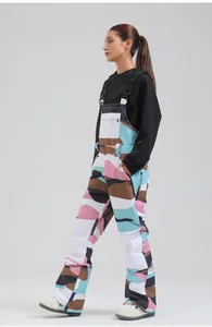 Side profile of women's professional colorful camouflage bib ski pants for winter.