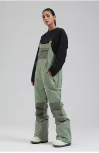 Professional women's sage green ski bib pants featuring waterproof quilted detailing