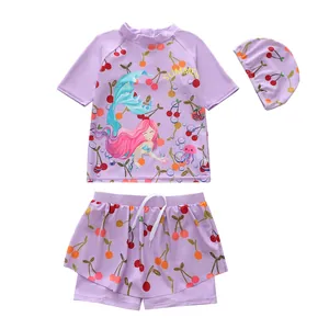 Detailed view of girls' three-piece purple mermaid swimsuit set featuring cherry patterns