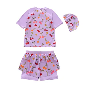Purple three-piece girls' swimsuit with cherry print including top, skirt and cap