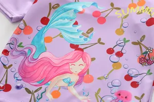 Close-up of vibrant mermaid and cherry pattern on purple sun protective girls swimwear