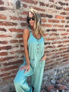 Detailed outdoor view of a mint green casual sleeveless jumpsuit with buttons.