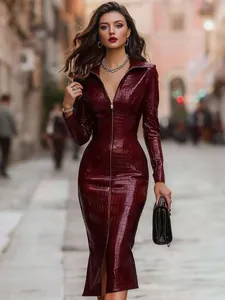 Detail of the sleek burgundy crocodile-texture midi dress featuring a full front zipper