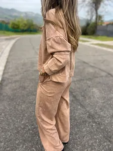Side view of woman wearing brown washed fabric loungewear set in outdoor setting