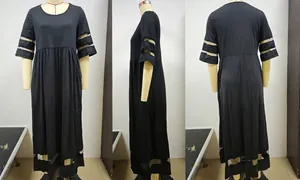 Detail view of plus size black dress featuring mesh patchwork on sleeves and the bottom hem