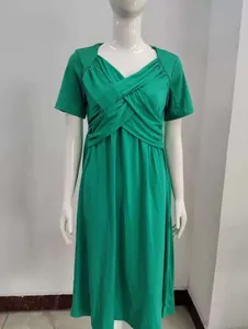 Elegant green summer short-sleeved dress featuring a unique criss-cross wrap bodice design