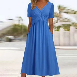 Bright blue short-sleeved A-line dress with V-neck wrap bodice and side pockets.