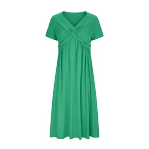 Elegant green summer dress featuring a stylish crossover v-neck and pleated short sleeves