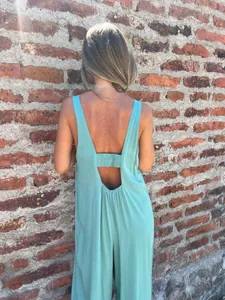 Back view of a casual mint green sleeveless jumpsuit with an elasticated V-back detail