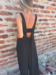 Detail of women's loose black jumpsuit showing the stylish backless design and strap.