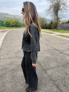 Detailed side view of women's acid wash grey oversized sweatshirt and matching pants set