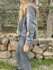 Two-piece grey acid wash loungewear set featuring oversized long-sleeve top and matching pants