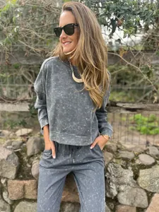 Detail showing women's grey acid-wash leisure tracksuit set with round neck and side pockets