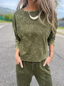 Olive green acid wash loungewear set with sweatshirt and joggers shown in street setting