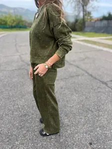 Detailed side view of women's olive green acid wash casual tracksuit set on outdoor road