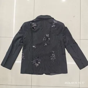 Back view of a vertical striped blazer with black sequin floral embroidery details