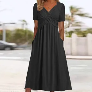 Elegant summer black short sleeve midi dress with crossover V-neck and functional side pockets