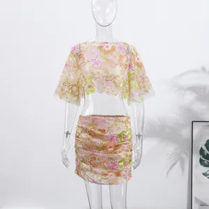 Detailed view of floral embroidery and sequins on two-piece cropped top and skirt set