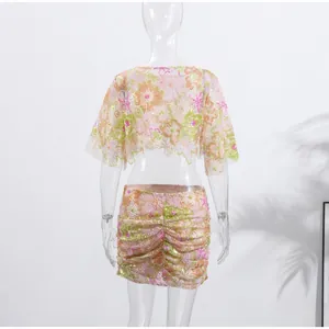 Back view of floral embroidered two-piece set with sequins and ruched skirt details.