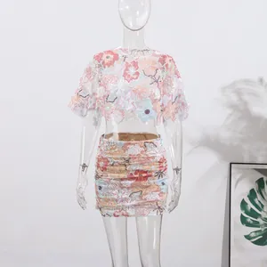 Detailed floral embroidery and sequins on summer crop top and mini skirt set design