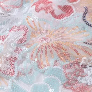 Detailed close-up macro view of intricate floral sequin embroidery on soft mesh fabric