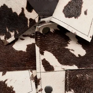Close-up detail van de koeienprint textuur en kraag op de jas met lange mouwen