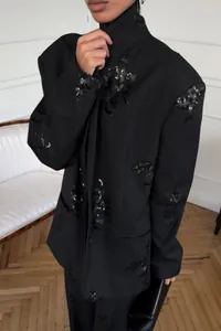 Elegant black blazer with sequin floral embroidery part of a wide leg pants suit