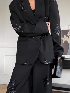 Elegant black pinstripe suit set with sequin floral embroidery blazer and wide-leg pants.