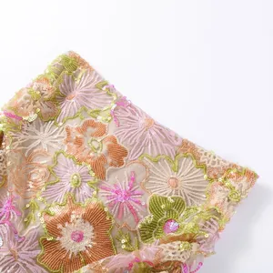 Detailed close-up of intricate floral embroidery and sequins on summer two-piece set