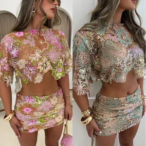 Detailed macro view of heavy floral embroidery and sequins on cropped top and mini skirt set
