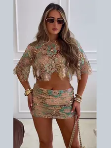 Full view of the sequin embroidered crop top and mini skirt two-piece set on a model.