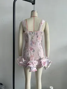 Back view detail of pink floral smocked mini dress with ruffled hem and lace straps