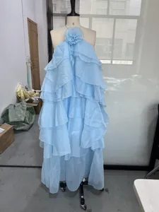 Front view of light blue tiered ruffled maxi dress with 3D floral halter neck on mannequin