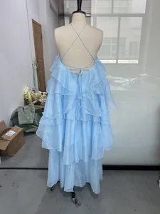 Back view of light blue tiered ruffle halter backless maxi dress displayed on mannequin