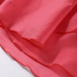 Close-up detail of the vibrant pink ruffled hem with professional overlock stitching.