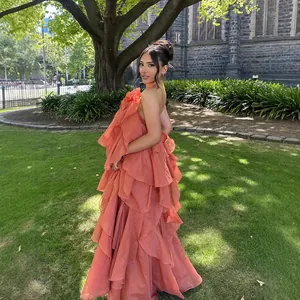 Close-up detail of layered ruffles on this elegant coral backless vacation maxi dress.