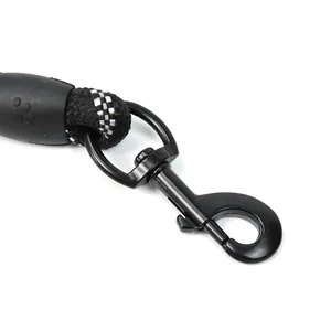 Close-up of durable black metal clasp on reflective nylon pet leash with paw print detail.