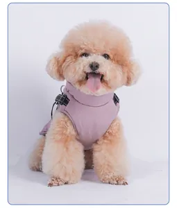 Detail of a poodle wearing a waterproof mauve winter dog vest with integrated harness