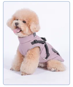 Close-up of waterproof pink dog winter jacket with integrated black harness straps