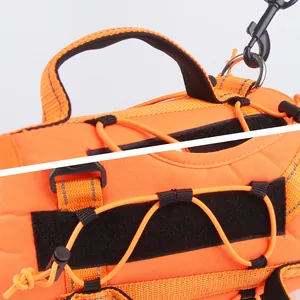 Detail of orange tactical dog harness with reflective stitching and metal D-ring.