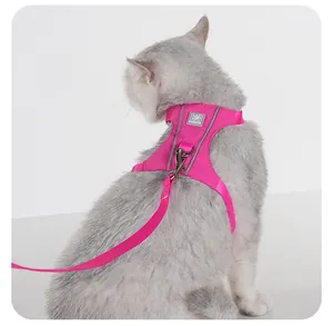 Detailed close-up of a pink reflective cat harness and leash set on a grey cat model