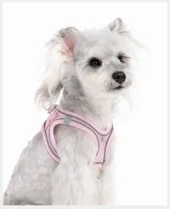 Detail of pink breathable mesh dog harness vest with reflective strips on a white dog