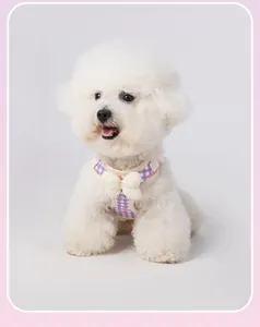 Detailed view of the purple checkered dog harness featuring a soft cream plush bow