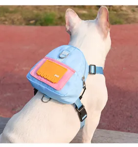 Close-up detail of the colorful cartoon pet backpack harness worn by a French Bulldog