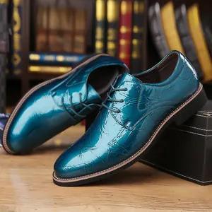 Close-up detail of the glossy teal blue crinkled patent leather formal men's shoes